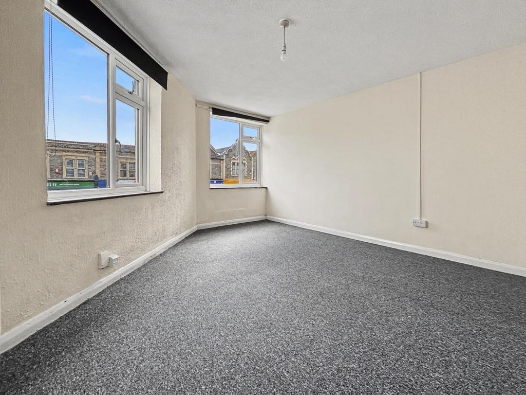 Bright, neutrally decorated double bedroom with...