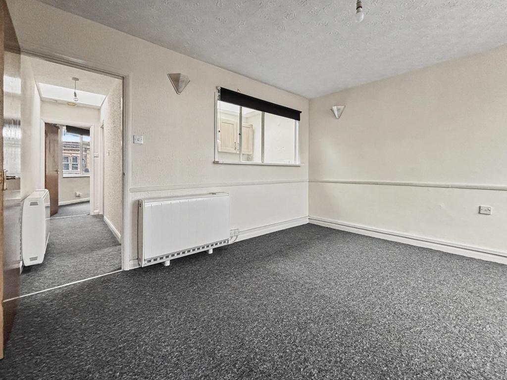Bright neutral-livered living room with large w...