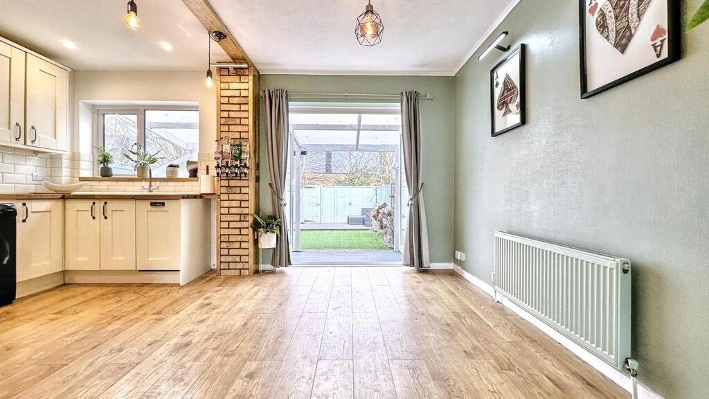 Bright open-plan kitchen/dining area with light...