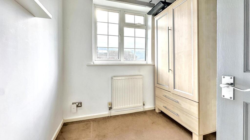 Bright single bedroom with a large window provi...