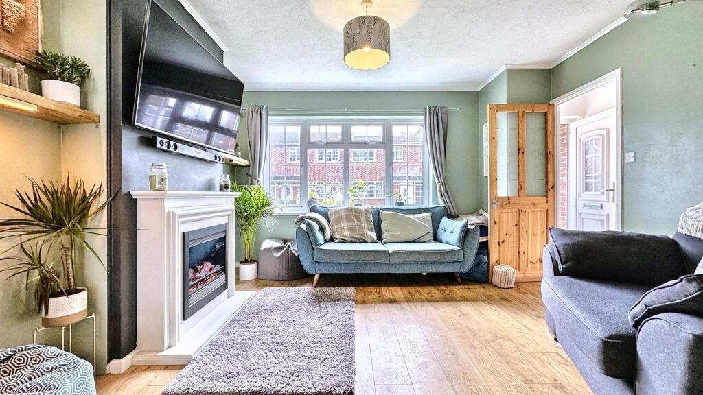 Bright, stylish living room with a central sofa...