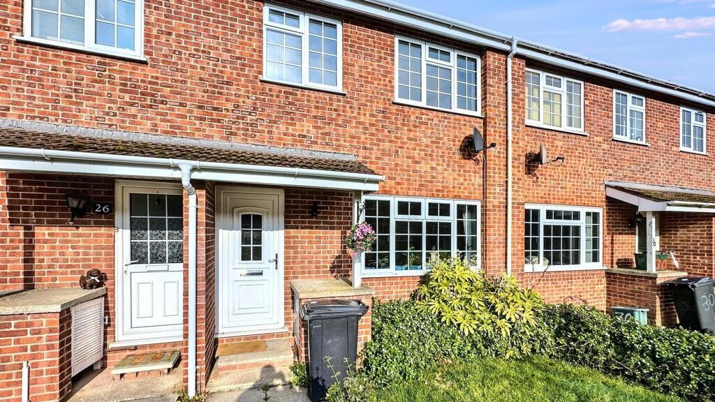 Well-maintained terraced house with red brick f...
