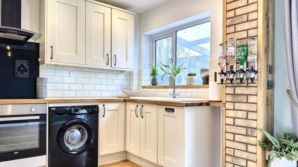 Bright modern kitchen with white shaker-style c...