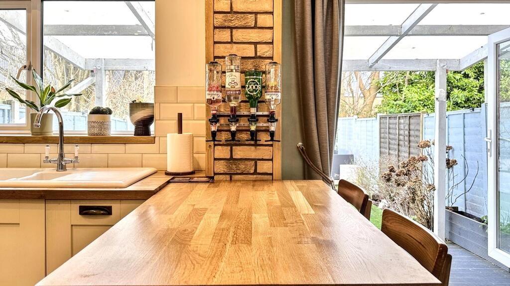 Bright contemporary kitchen with a large wooden...