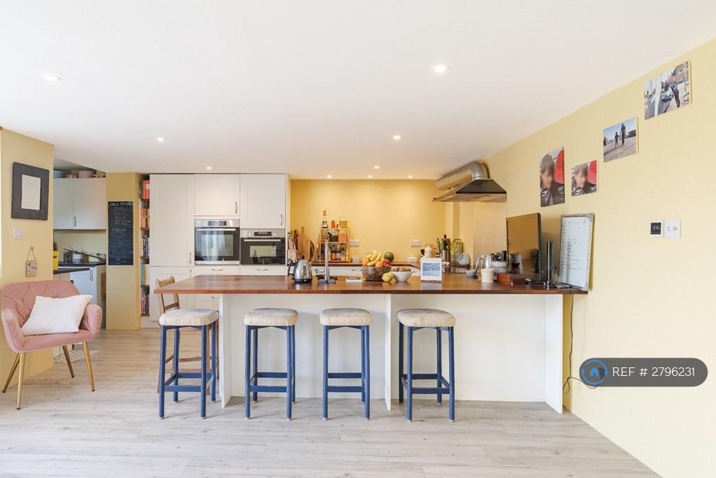 Fitted Kitchen And Breakfast Bar With Service Sink