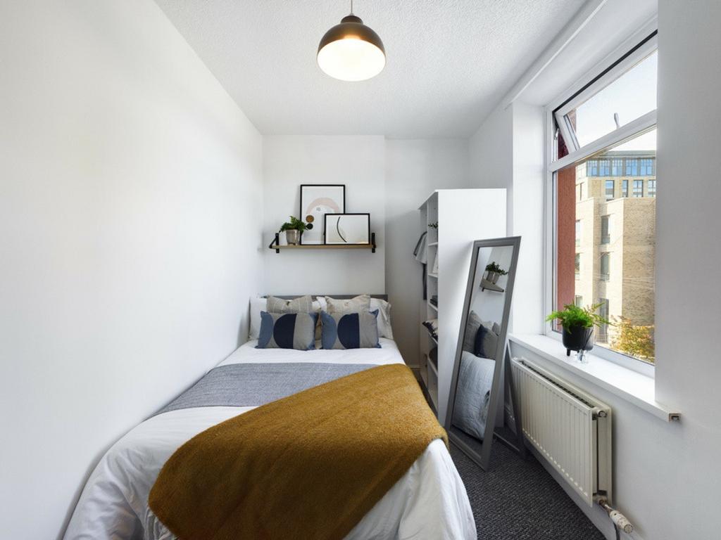 A bright and inviting double bedroom featuring ...