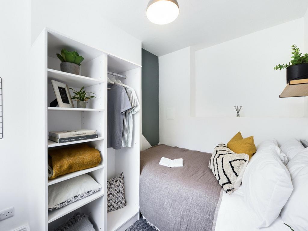 A bright and tidy double bedroom featuring styl...