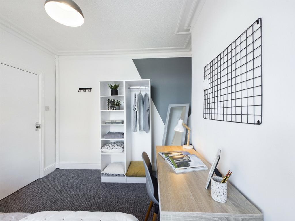 A bright and stylish double bedroom featuring a...
