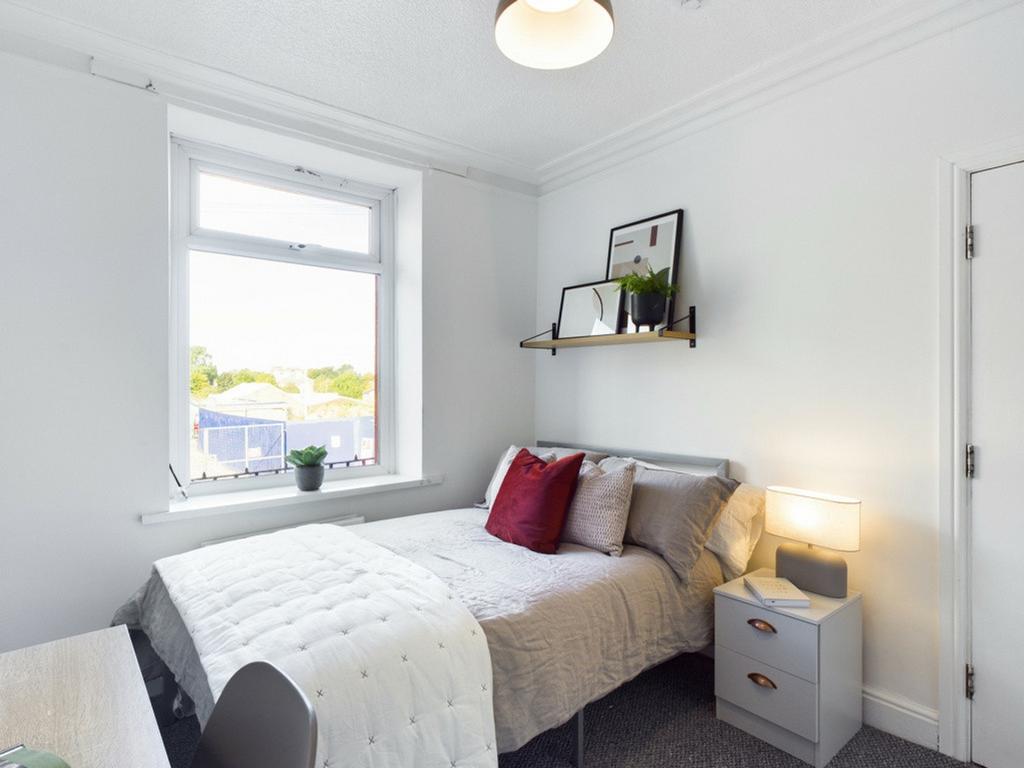 A bright and inviting double bedroom featuring ...