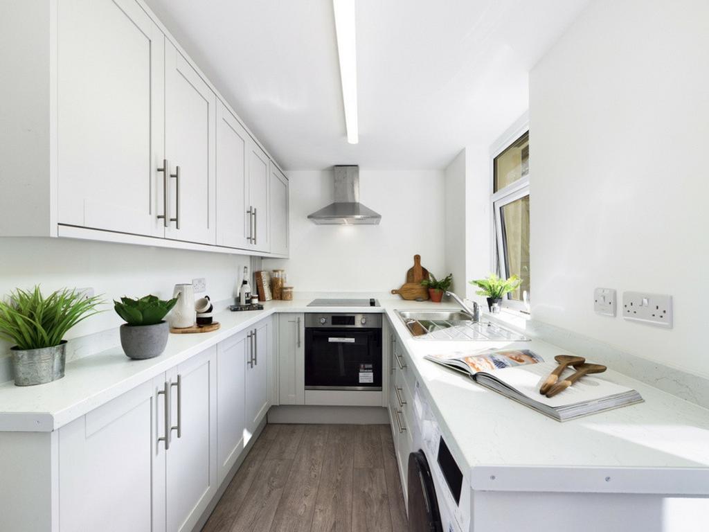 A bright and modern kitchen with sleek cabinetr...