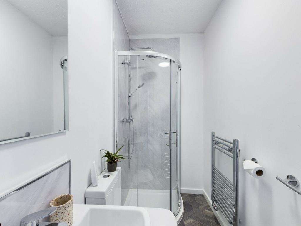 A modern and pristine bathroom featuring a styl...