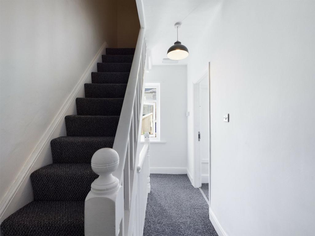 A clean and inviting hallway with stylish decor...