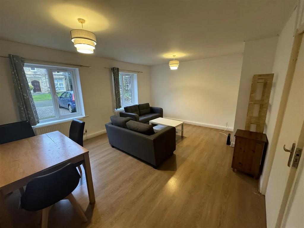 Bright and spacious living room with large wind...