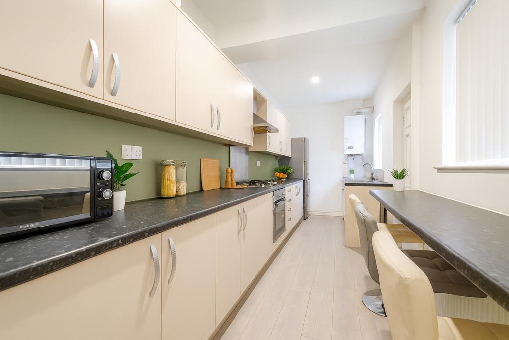 Bright and modern kitchen with ample cupboard s...