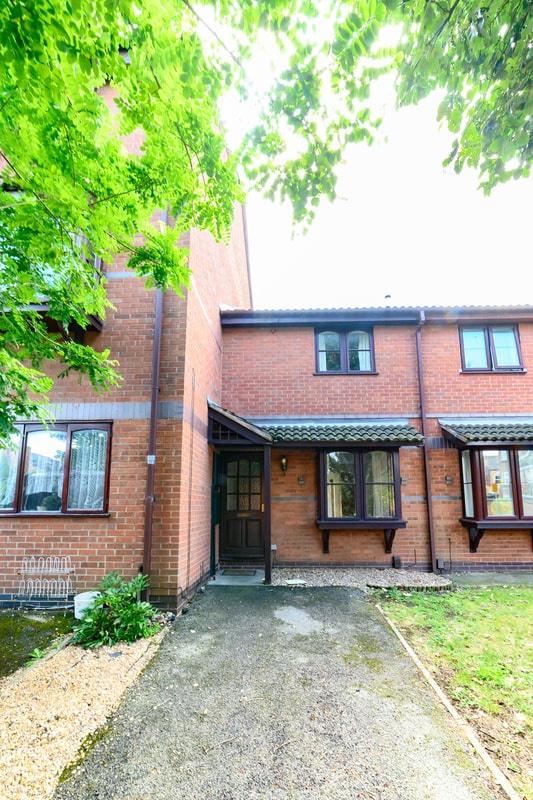 Red-brick terraced home with a covered porch, b...
