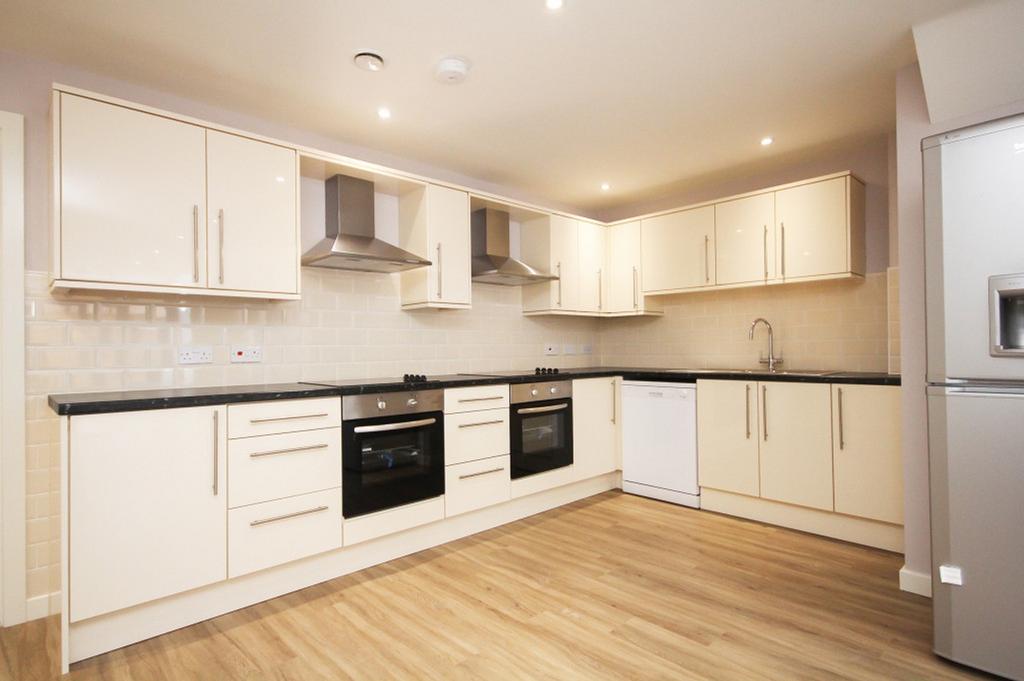 A spacious and modern kitchen, featuring sleek ...