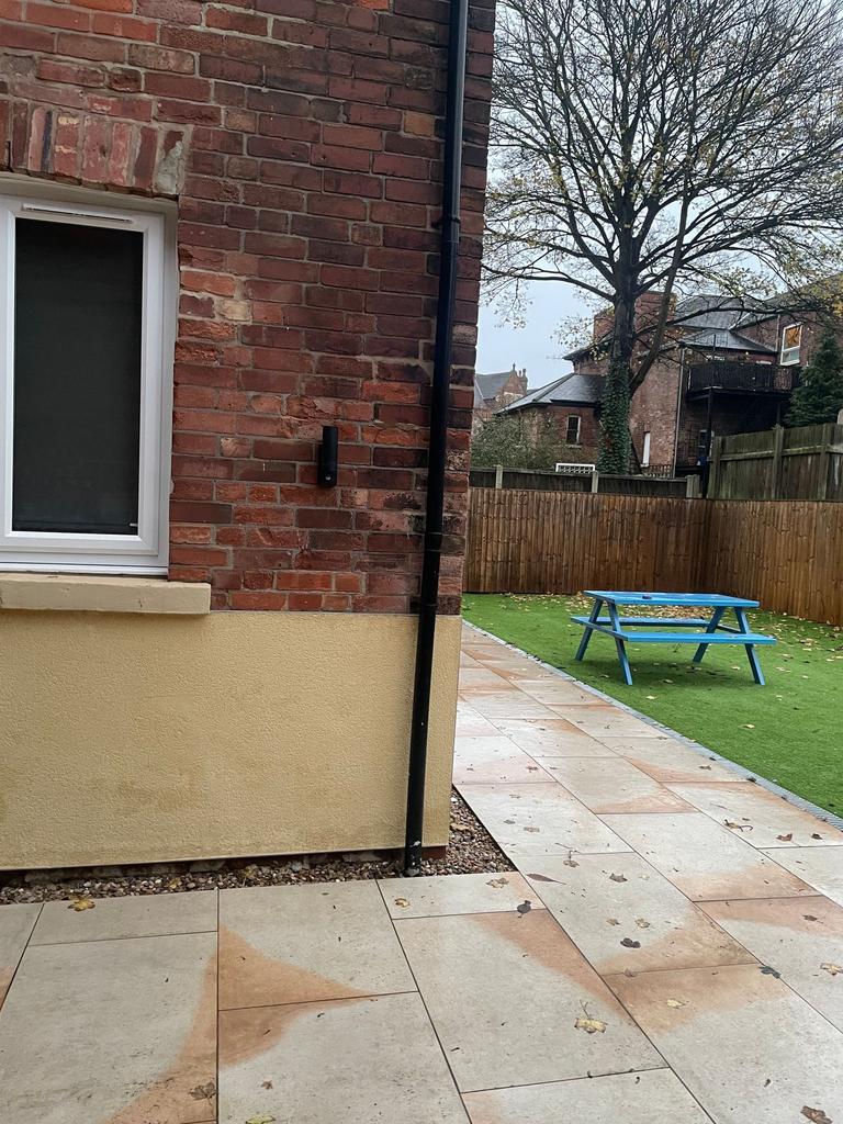 Well-maintained private rear garden with paved ...