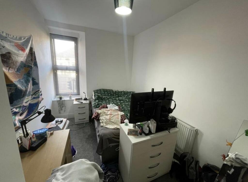 Bright single bedroom with a large window, simp...