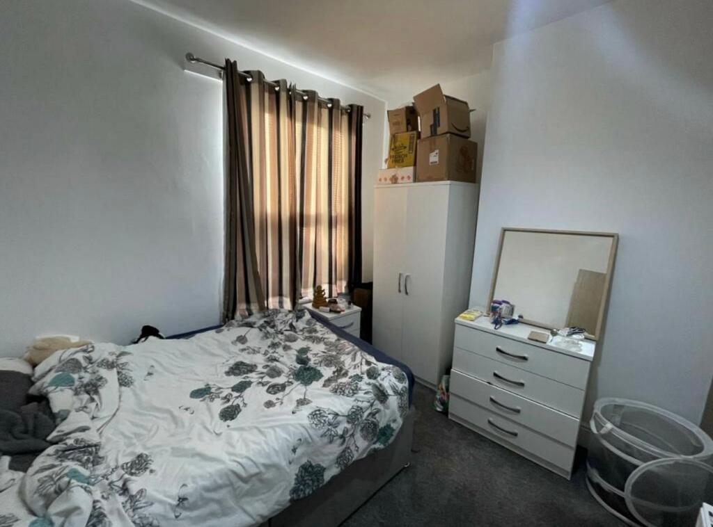 Bright furnished bedroom with a double bed, war...
