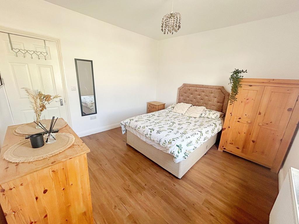 Bright and cozy double bedroom featuring a comf...