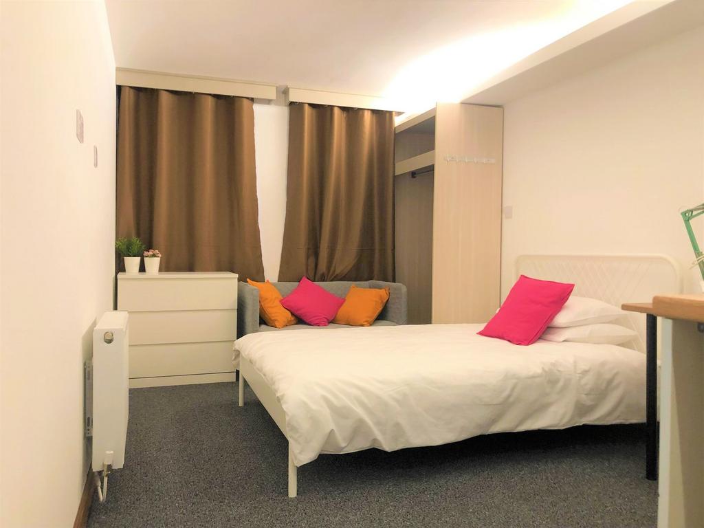 A cozy and well-kept double bedroom featuring a...