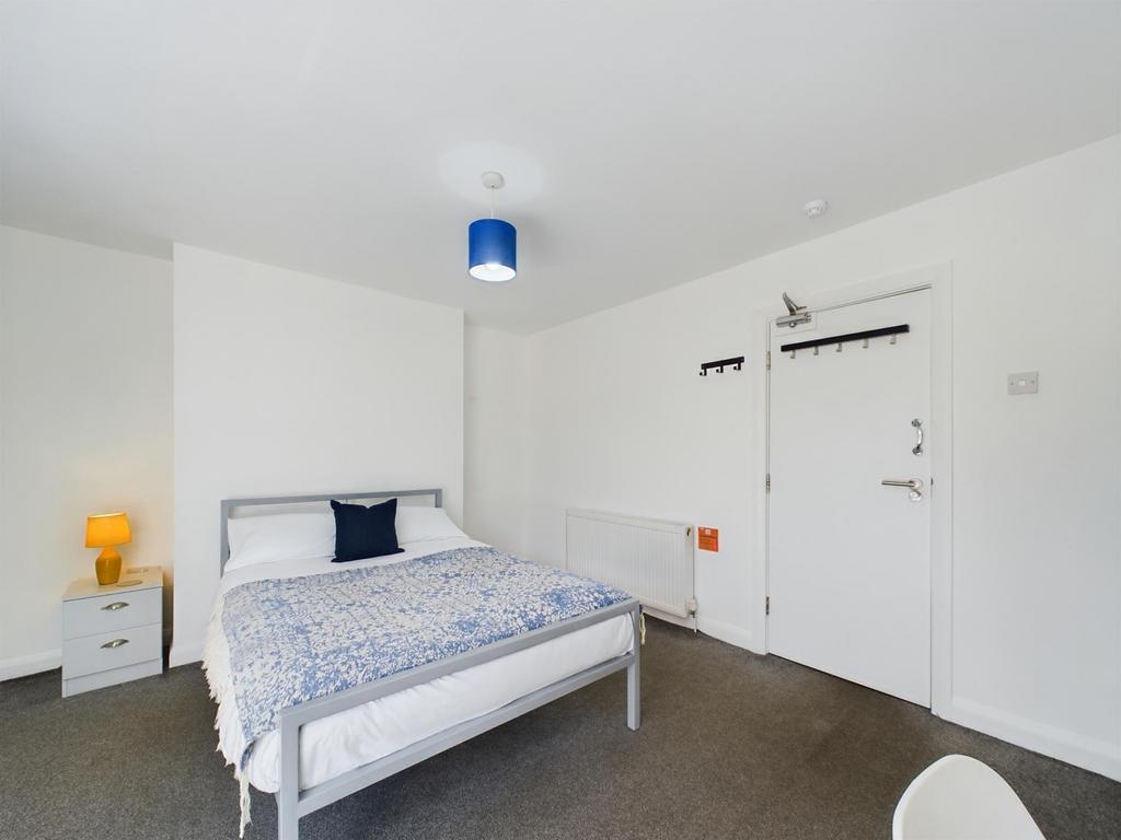 Bright and tidy double bedroom featuring a larg...