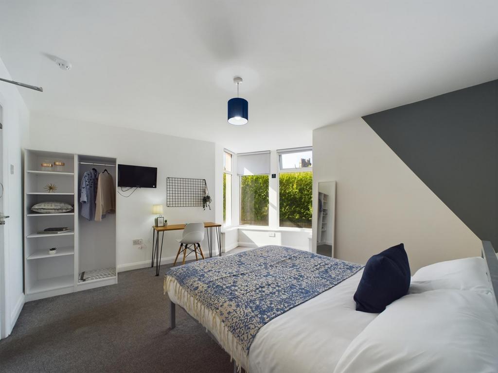 A bright, well-maintained bedroom featuring a c...