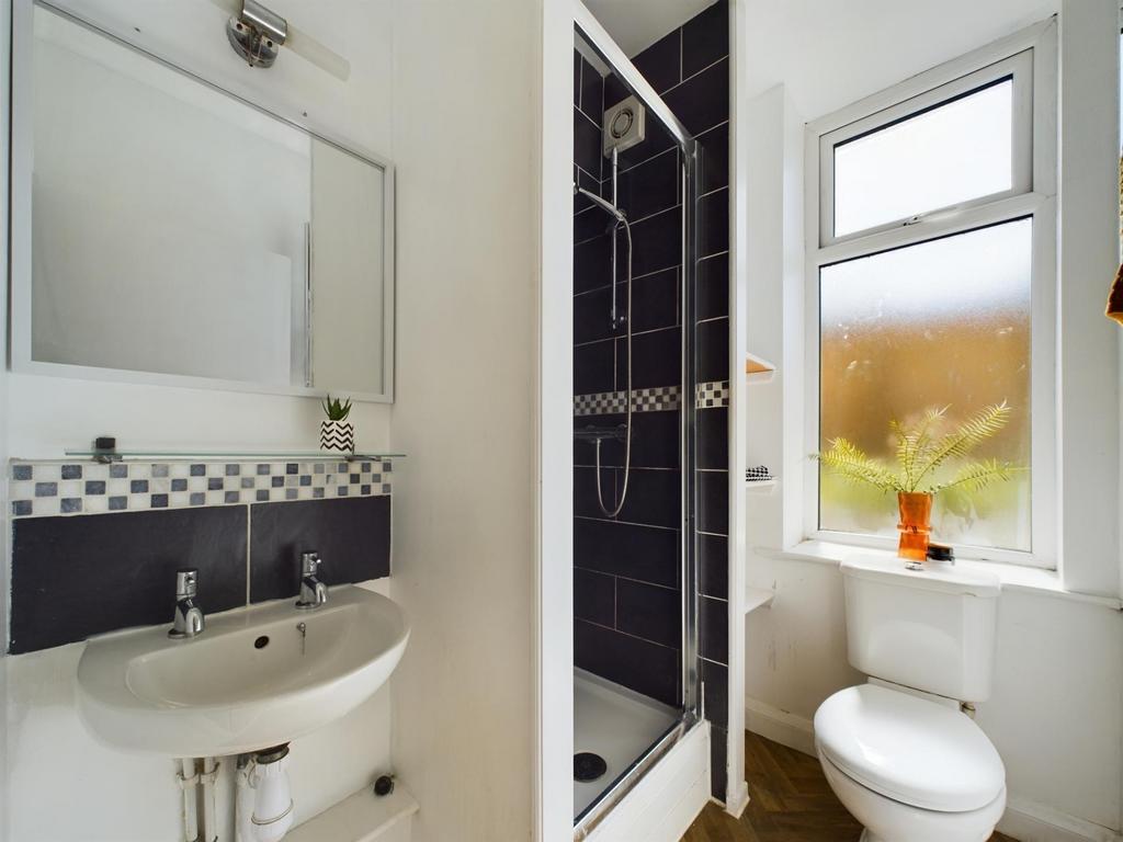 A bright and clean bathroom suite featuring a s...