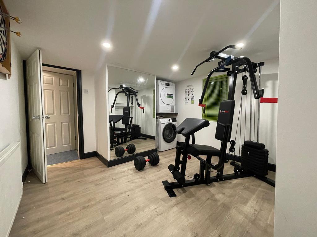 Well-equipped private gym room with multi-stati...