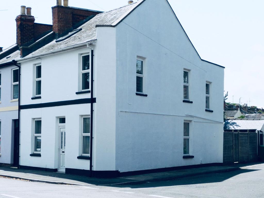 Bright painted corner house with a fresh white ...