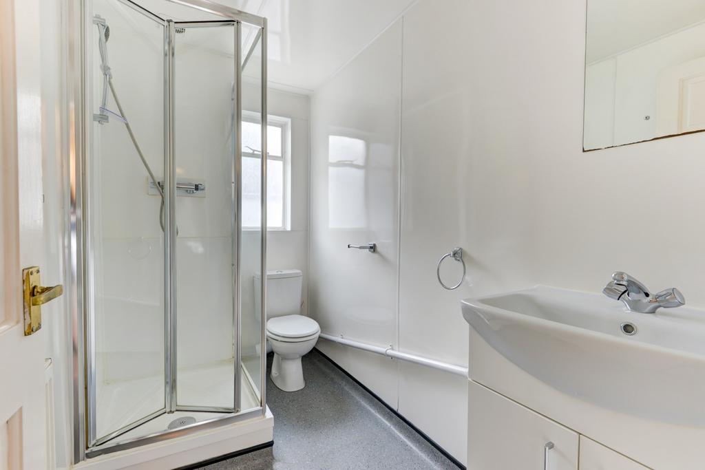 Bright, well-maintained bathroom featuring a se...