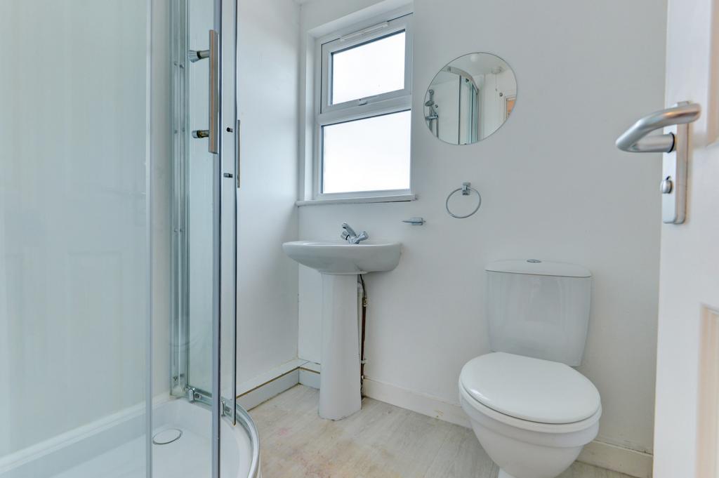 A clean and bright bathroom featuring a toilet,...
