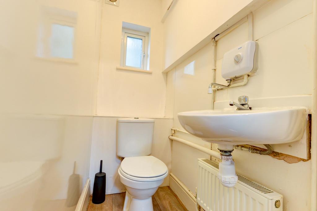 Compact, well-kept bathroom with a wall-mounted...