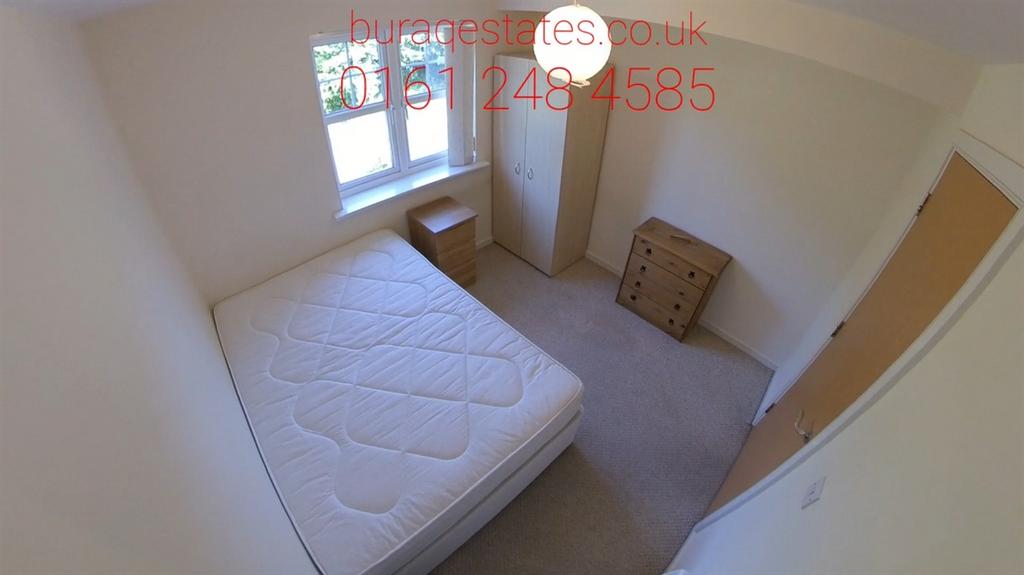 Bright, simply furnished bedroom with a double ...