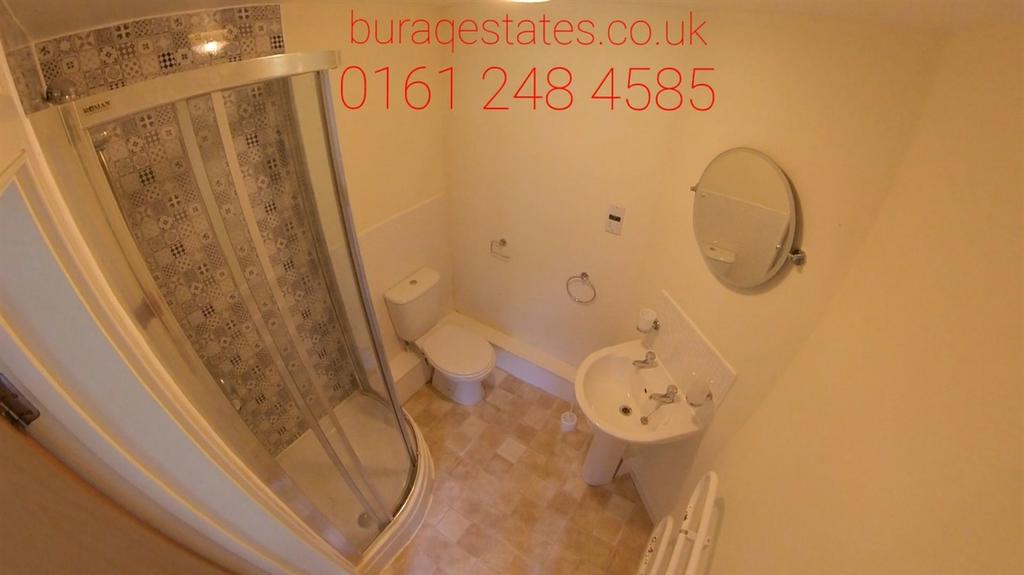 Bright, well-maintained bathroom with a curved ...