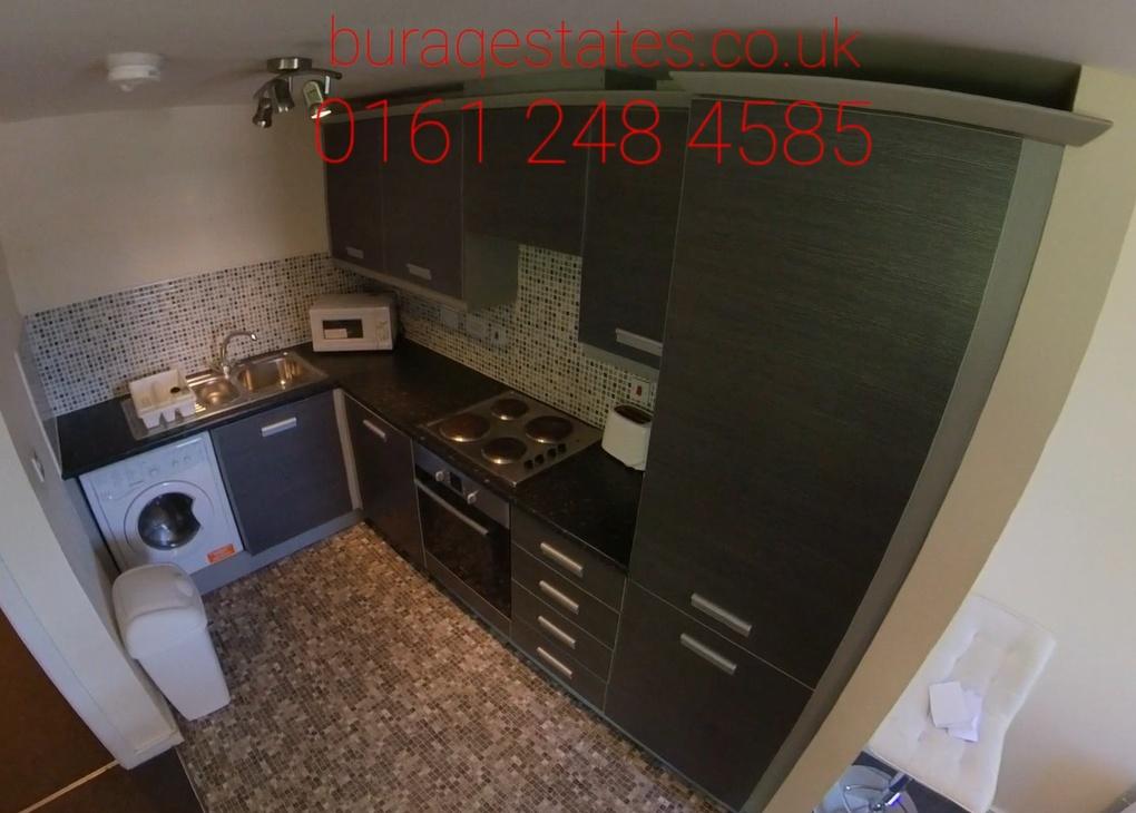 Compact fitted kitchen with modern dark cabinet...