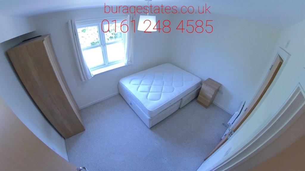 Bright, simply furnished bedroom with a double ...