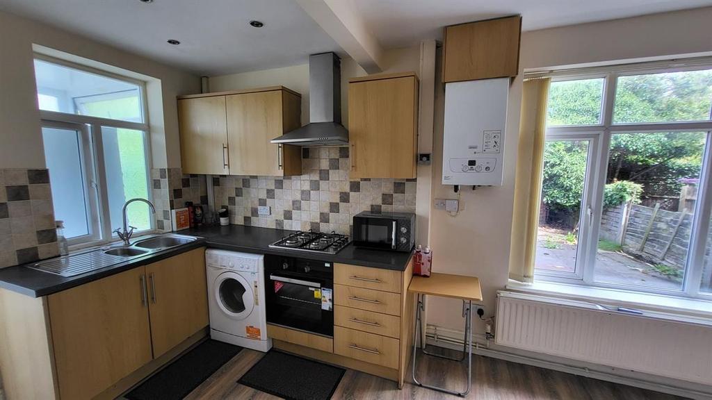 Bright fitted kitchen with light wood cabinetry...