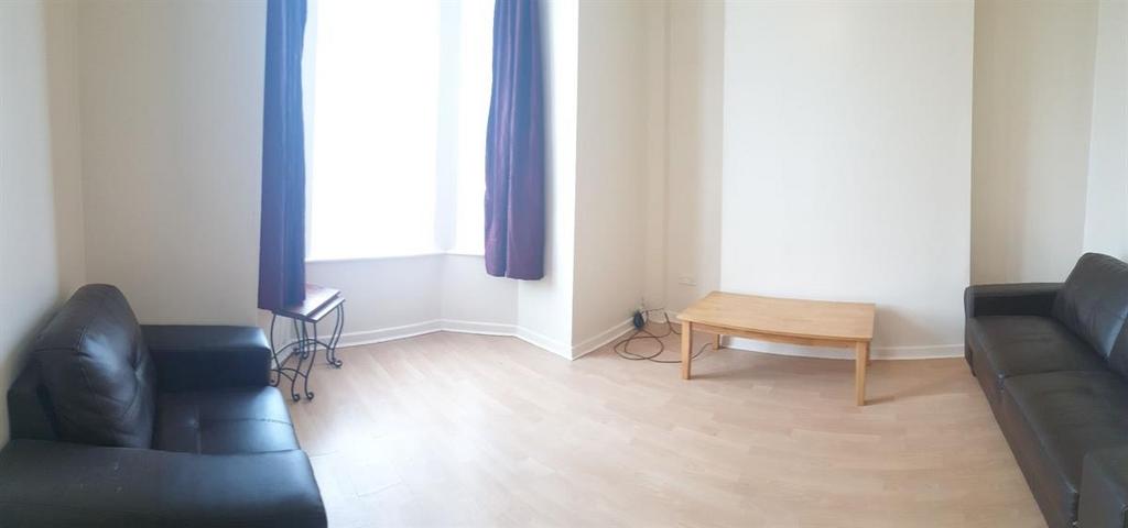 Bright living room with large bay window, light...