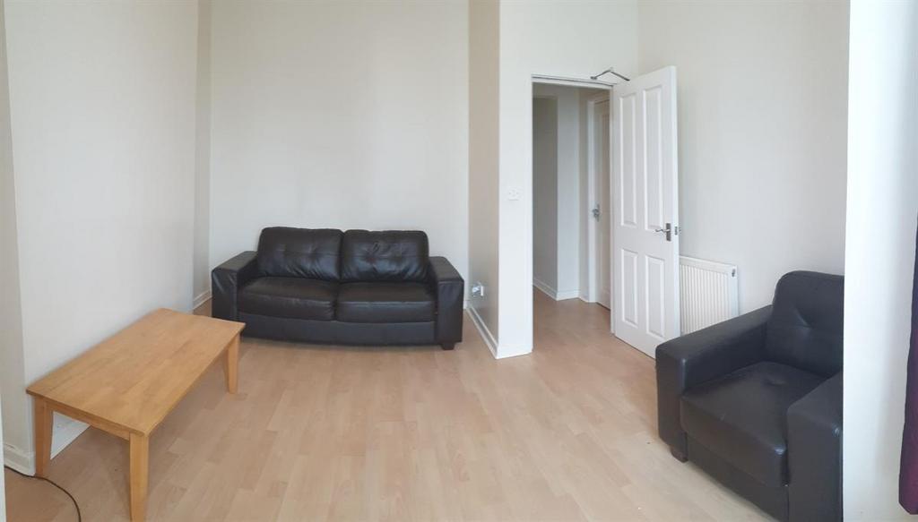 Bright, simply furnished living room with light...