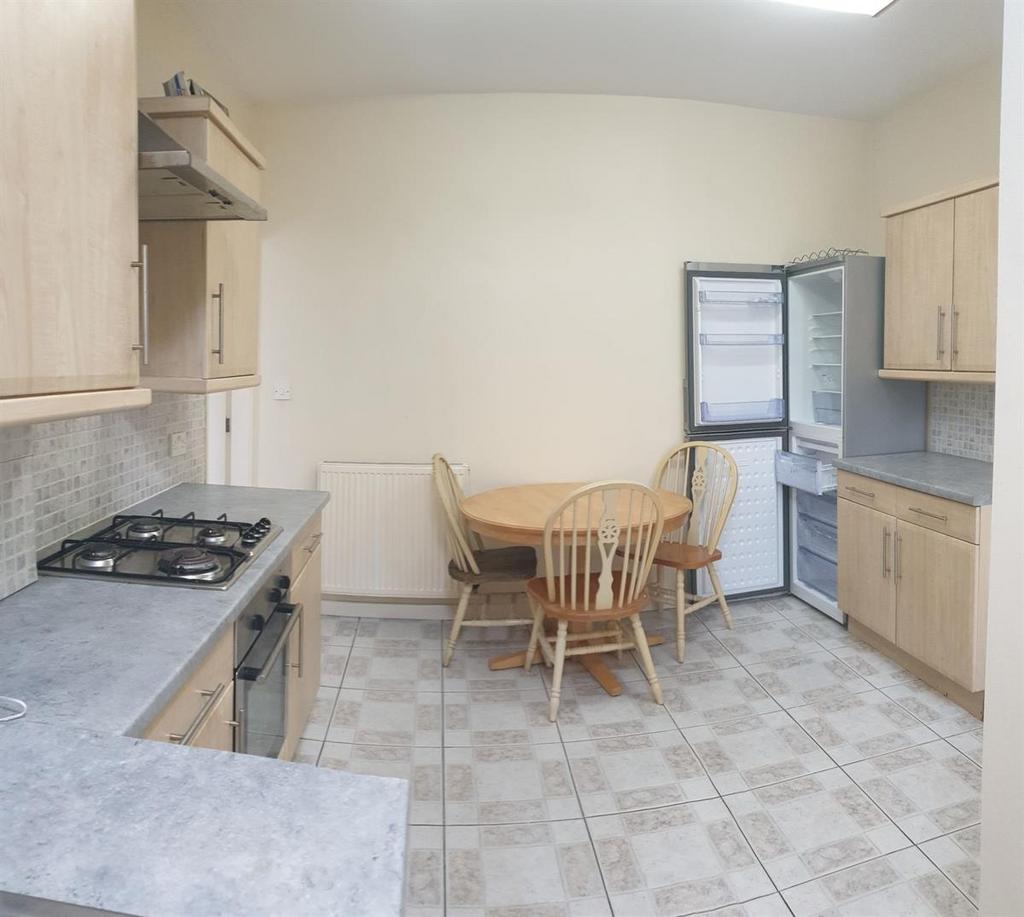 Bright, well-equipped kitchen featuring built-i...