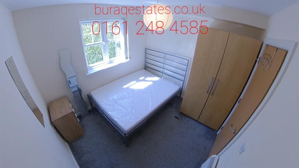 Bright, simply furnished bedroom with a double ...