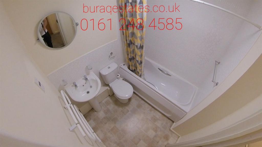 Compact, well-kept bathroom with a clean white ...