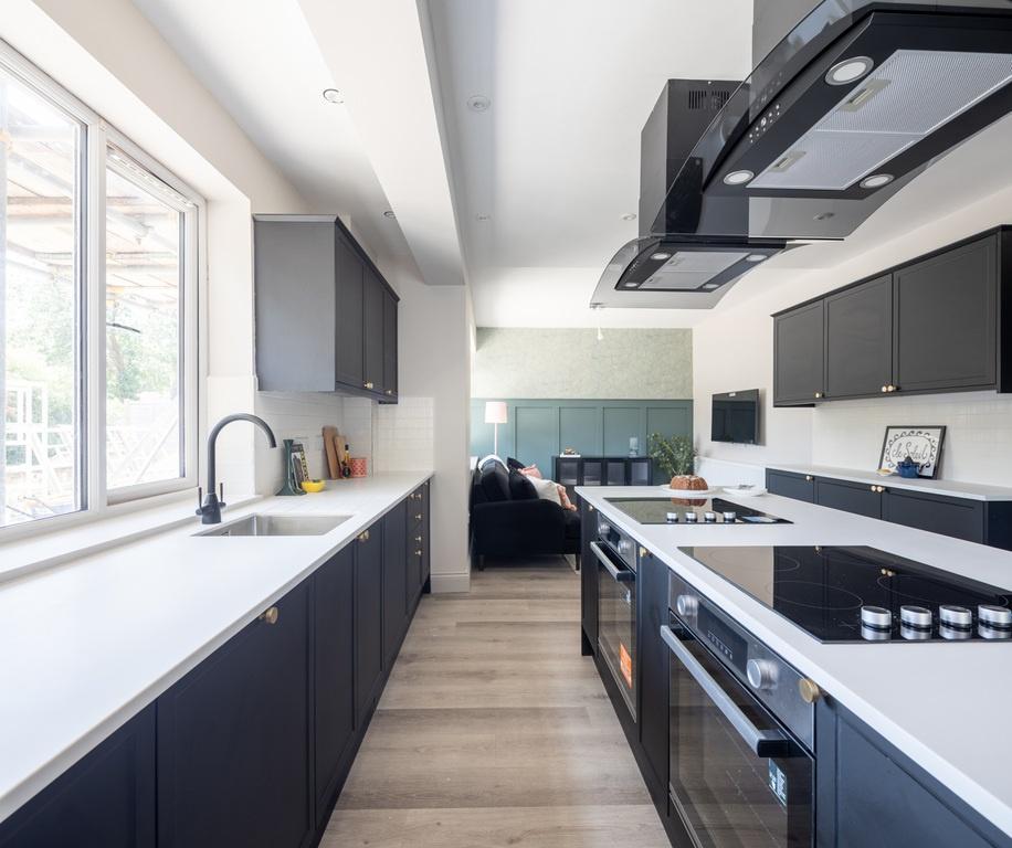 Bright modern kitchen with sleek dark cabinetry...