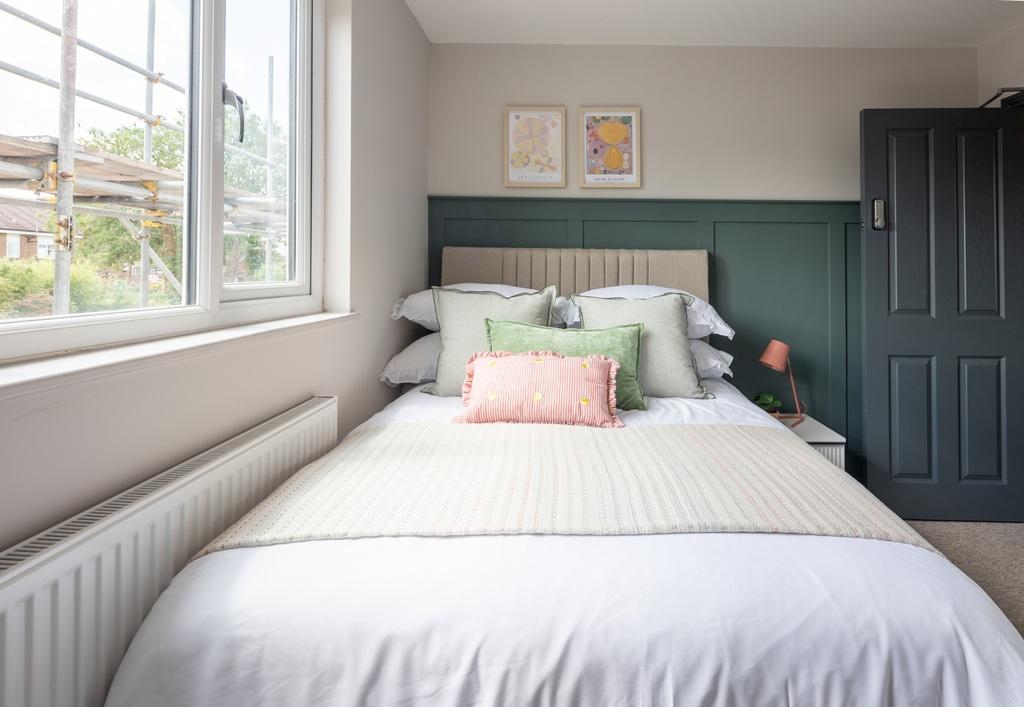 Bright, neatly styled double bedroom with a com...