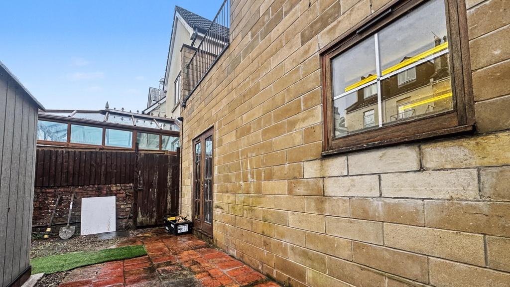 Stone-walled exterior courtyard with paved pati...