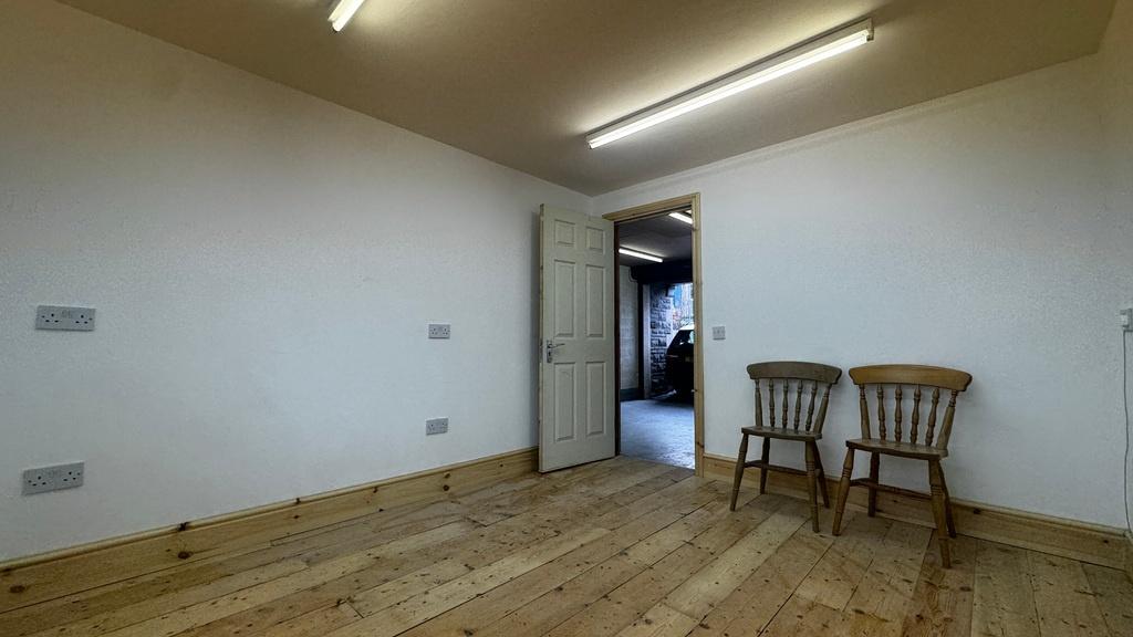 Bright, simply furnished communal space with po...