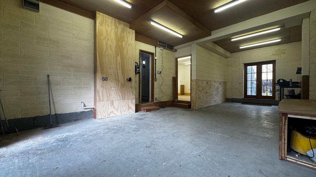 Spacious, well-lit garage/workshop with high ce...