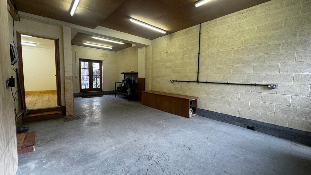 Large, clean garage/storage space with concrete...
