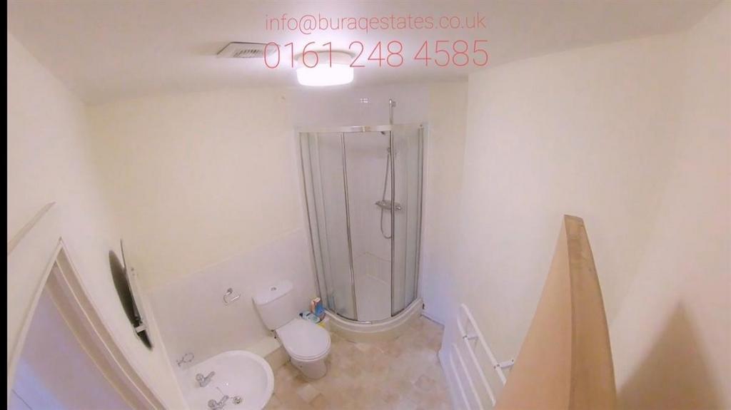 Bright, clean bathroom with modern corner showe...